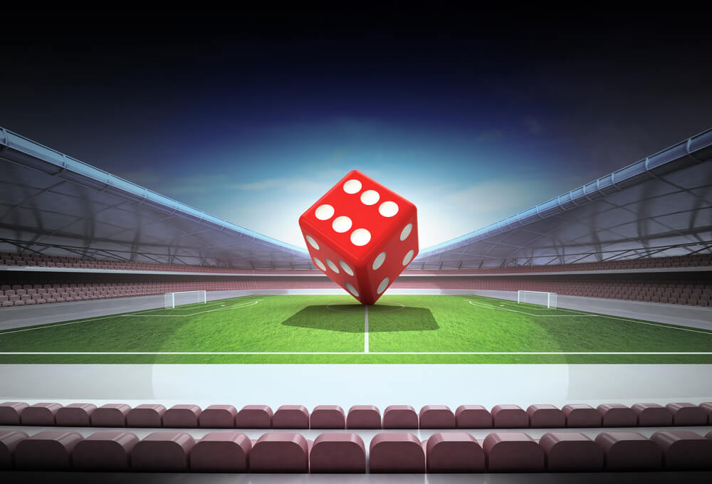 An image of a dice in the middle of a soccer stadium